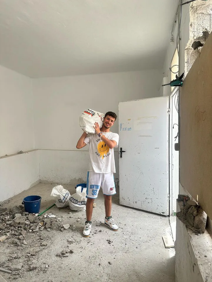 Taha carrying construction debris while volunteering at a hostel in Las Palmas, Gran Canaria
